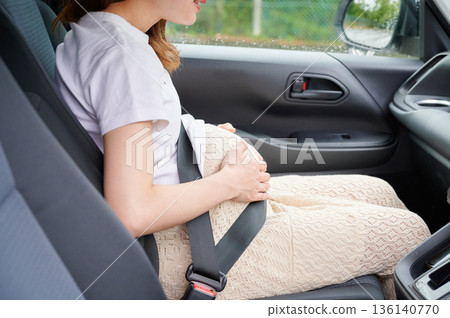 Driving woman, pregnant woman, child 136140770