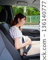 Driving woman, pregnant woman, child 136140777