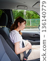 Driving woman, pregnant woman, child 136140779