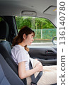 Driving woman, pregnant woman, child 136140780