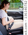 Driving woman, pregnant woman, child 136140782