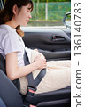 Driving woman, pregnant woman, child 136140783