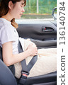 Driving woman, pregnant woman, child 136140784