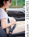 Driving woman, pregnant woman, child 136140785