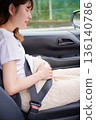 Driving woman, pregnant woman, child 136140786