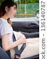 Driving woman, pregnant woman, child 136140787