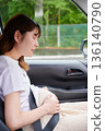 Driving woman, pregnant woman, child 136140790