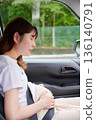 Driving woman, pregnant woman, child 136140791