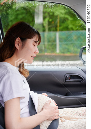 Driving woman, pregnant woman, child Driving woman, pregnant woman, child 136140792