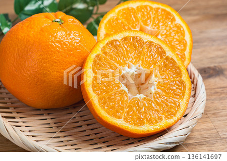 Iyokan oranges served on a bamboo basket 136141697