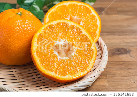 Iyokan oranges served on a bamboo basket Iyokan oranges served on a bamboo basket 136141698