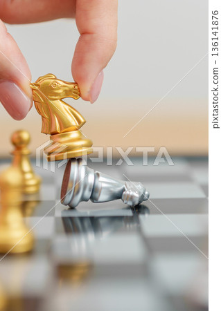 hand moving gold Chess King figure and Checkmate opponent during chessboard competition. Strategy, Success, management, business planning, win, disruption, Trade war and leadership concept hand moving gold Chess King figure and Checkmate opponent during chessboard competition. Strategy, Success, management, business planning, win, disruption, Trade war and leadership concept 136141876