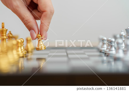 hand moving gold Chess King figure and Checkmate opponent during chessboard competition. Strategy, Success, management, business planning, win, disruption, Trade war and leadership concept hand moving gold Chess King figure and Checkmate opponent during chessboard competition. Strategy, Success, management, business planning, win, disruption, Trade war and leadership concept 136141881