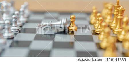 hand moving gold Chess Pawn figure and Checkmate opponent during chessboard competition. Strategy, Success, management, business planning, win, disruption, Trade war and leadership concept hand moving gold Chess Pawn figure and Checkmate opponent during chessboard competition. Strategy, Success, management, business planning, win, disruption, Trade war and leadership concept 136141883