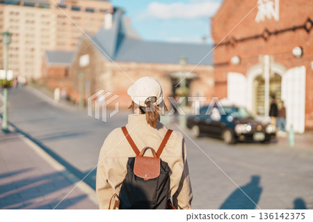 Woman tourist Visiting in Hakodate, happy Traveler sightseeing Kanemori Red Brick Warehouse in spring season. landmark and popular for attractions in Hokkaido, Japan. Travel and Vacation concept 136142375