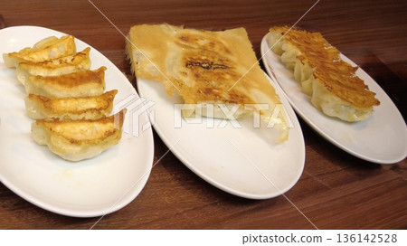 Fried dumplings served on a plate Fried dumplings served on a plate 136142528