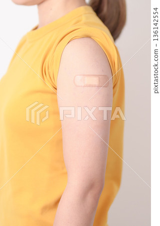 Adult Woman with bandage after received vaccine. Vaccination and Immunization for Influenza, HPV, Zoster, IPD, DTP or Diphtheria, Tetanus and Pertussis, MMR, Hepatitis B, Covid and Nipha virus vaccine Adult Woman with bandage after received vaccine. Vaccination and Immunization for Influenza, HPV, Zoster, IPD, DTP or Diphtheria, Tetanus and Pertussis, MMR, Hepatitis B, Covid and Nipha virus vaccine 136142554