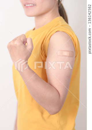 Adult Woman with bandage after received vaccine. Vaccination and Immunization for Influenza, HPV, Zoster, IPD, DTP or Diphtheria, Tetanus and Pertussis, MMR, Hepatitis B, Covid and Nipha virus vaccine 136142562
