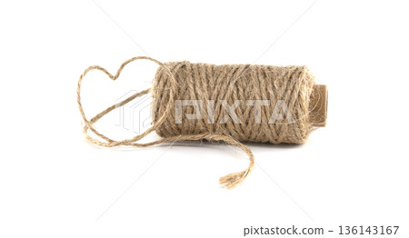 Heart shape made from twine on a spool, symbolizing love and craft 136143167