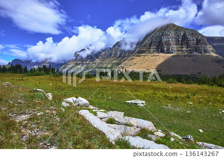 Majestic Mountain Landscape with Alpine Meadow and Dramatic Cloud Formations Majestic Mountain Landscape with Alpine Meadow and Dramatic Cloud Formations 136143267