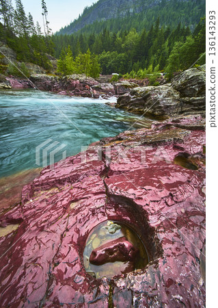 Red Rock Formations Turquoise River and Evergreen Forest at Glacier National Park Red Rock Formations Turquoise River and Evergreen Forest at Glacier National Park 136143293