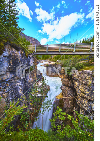 Waterfall Rushing River Bridge and Marble Canyon with Lush Greenery 136143311