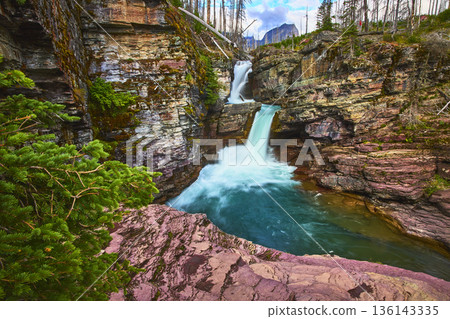 Saint Mary Falls Rushing Waterfall and Rocky Cliffs in Lush Glacier Wilderness 136143335