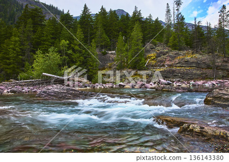 Rushing River Cascade and Red Rock Formations in Lush Mountain Forest Rushing River Cascade and Red Rock Formations in Lush Mountain Forest 136143380