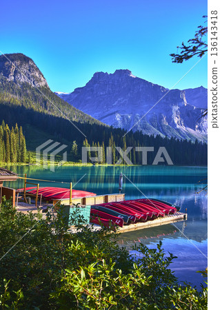 Emerald Lake Dock Red Canoes and Majestic Mountain Reflections in Morning Light Emerald Lake Dock Red Canoes and Majestic Mountain Reflections in Morning Light 136143418