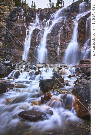 Majestic Multi Tier Waterfall Flowing Over Rocky Cliffs With Cascading Water in Nature 136143458