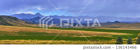 Panoramic Wyoming Mountain Landscape with Rolling Fields and Dramatic Sky Layers 136143466