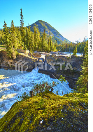 Natural Bridge Rushing River and Mountain Sunrise in Lush Forest Landscape 136143496