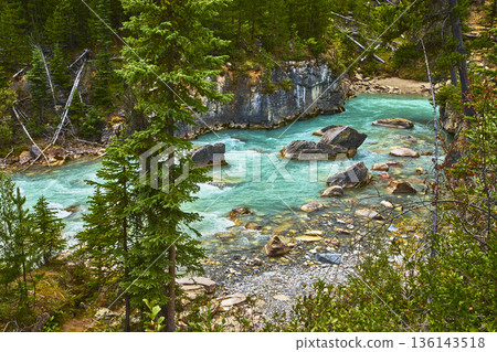 Turquoise River Flowing Through Rocky Canyon and Forest in Pristine Wilderness 136143518