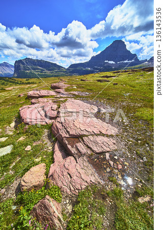 Hidden Lake Trail Montana Rocky Foreground and Majestic Mountain Under Summer Sky 136143536