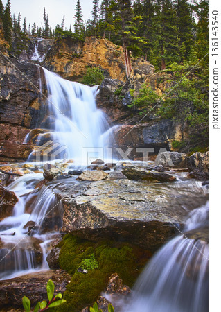 Tangle Falls Waterfall Flowing Over Rocks Surrounded by Forest in Jasper National Park 136143540