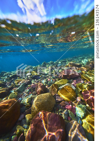Colorful Underwater Lake Rocks and Crystal Clear Water Split Shot Perspective Colorful Underwater Lake Rocks and Crystal Clear Water Split Shot Perspective 136143574