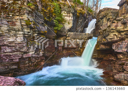 Saint Mary Falls Rushing Waterfall and Layered Rock Cliffs in Montana National Park 136143660