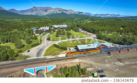 Aerial Train Station and Mountain Lodge with Lush Forest and Distant Peaks Aerial Train Station and Mountain Lodge with Lush Forest and Distant Peaks 136143678