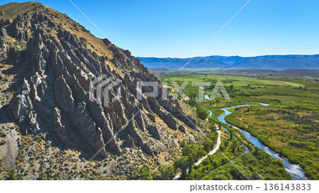 Aerial Rocky Cliffs Meandering River and Vast Green Valley Wyoming Aerial Rocky Cliffs Meandering River and Vast Green Valley Wyoming 136143833