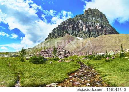 Mountain Peak Stream and Alpine Meadow Under Bright Blue Sky 136143840