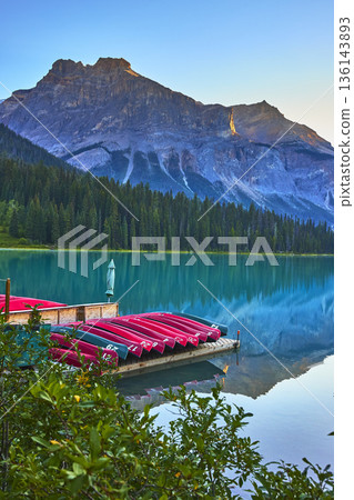 Emerald Lake Dock with Canoes and Mountain Reflections in Tranquil Water Emerald Lake Dock with Canoes and Mountain Reflections in Tranquil Water 136143893