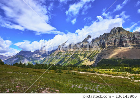 Majestic Mountain Range and Alpine Meadow Under Vibrant Sky in Pristine Wilderness 136143900
