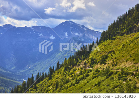Mountain Peaks Lush Forested Hillside and Dramatic Sky in Summer Mountain Peaks Lush Forested Hillside and Dramatic Sky in Summer 136143920