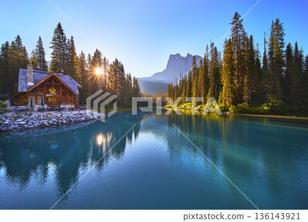 Sunrise Lodge Reflected in Tranquil Lake with Forest and Mountain View Golden Hour Sunrise Lodge Reflected in Tranquil Lake with Forest and Mountain View Golden Hour 136143921