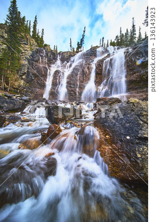 Tangle Falls Waterfall Flowing Over Rocky Cliffs With Evergreen Trees In Jasper Tangle Falls Waterfall Flowing Over Rocky Cliffs With Evergreen Trees In Jasper 136143923