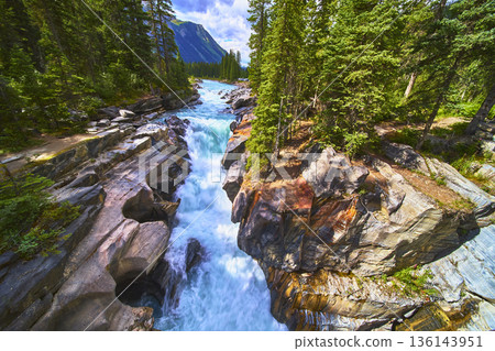 Numa Falls Waterfall Cascading Through Forested Rocky Canyon with Mountain View Numa Falls Waterfall Cascading Through Forested Rocky Canyon with Mountain View 136143951