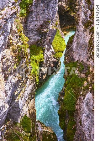 Aerial Turquoise River Flowing Through Mossy Rocky Canyon Walls Aerial Turquoise River Flowing Through Mossy Rocky Canyon Walls 136143954