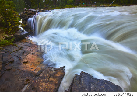 Athabasca Falls Rushing Water Over Rocky Ledge and Evergreen Forest 136144023