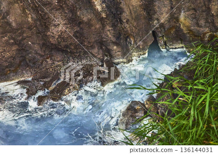 Cold Sulphur Spring Flowing From Rocky Cliff Beside Lush Green Grass Cold Sulphur Spring Flowing From Rocky Cliff Beside Lush Green Grass 136144031