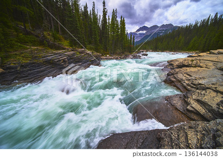 Mistaya Canyon Rapids with Turquoise River Forest and Mountain Landscape in Canada Mistaya Canyon Rapids with Turquoise River Forest and Mountain Landscape in Canada 136144038